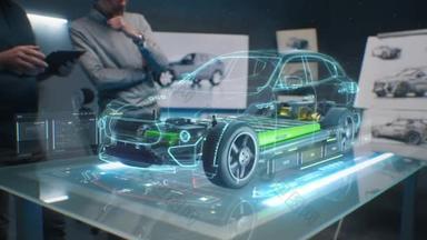 汽车设计工程师在数字平板电脑中使用全息应用。以可持续的标准，发展现代高科技尖端环保电动汽车。他们测试空气动力特性
